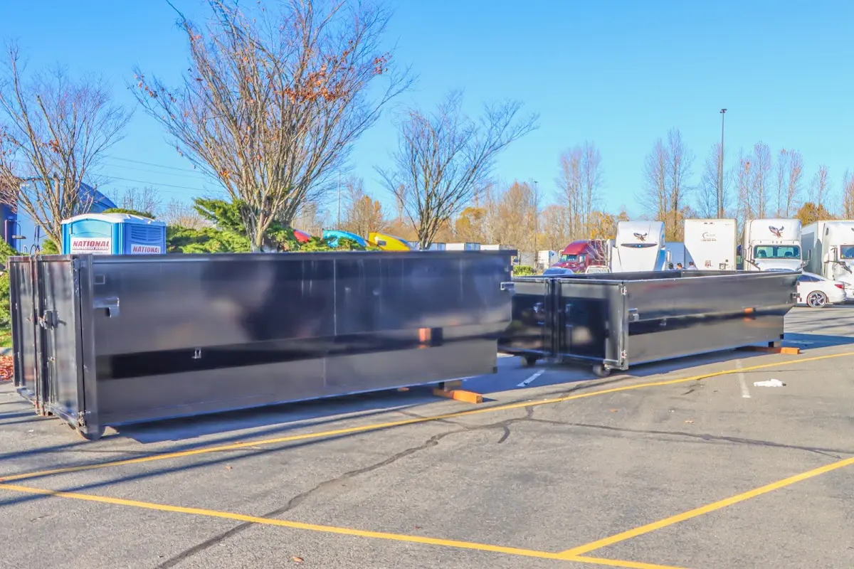 Professional dumpster rental service with roll-off container on residential driveway in Lynn